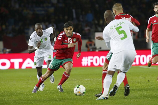 Morocco's Abdelilah Hafidi (18) challenges the ball with Mauritania's Mohamed Wade, left and Sidi Mohamed Bilal, right, during their CHAN (African Nations Championship) opening group A soccer match in Casablanca, Morocco, Saturday, Jan. 13, 2018.  (AP Photo/Abdeljalil Bounhar)