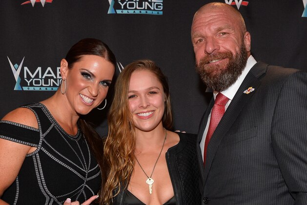 LAS VEGAS, NV - SEPTEMBER 12:  (L-R) WWE Chief Brand Officer Stephanie McMahon, MMA fighter Ronda Rousey and WWE Executive Vice President of Talent, Live Events and Creative Paul 'Triple H' Levesque appear on the red carpet of the WWE Mae Young Classic on September 12, 2017 in Las Vegas, Nevada.  (Photo by Bryan Steffy/Getty Images for WWE)
