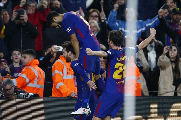 FC Barcelona's Lionel Messi celebrates after scoring with his teammates during the Spanish La Liga soccer match between FC Barcelona and Alaves at the Camp Nou stadium in Barcelona, Spain, Sunday, Jan. 28, 2018. (AP Photo/Manu Fernandez)