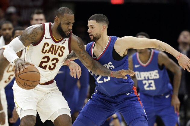 Cleveland Cavaliers' LeBron James (23) works against Los Angeles Clippers' Austin Rivers (25) during the second half of an NBA basketball game, Friday, Nov. 17, 2017, in Cleveland. The Cavaliers won 118-113 in overtime. (AP Photo/Tony Dejak)