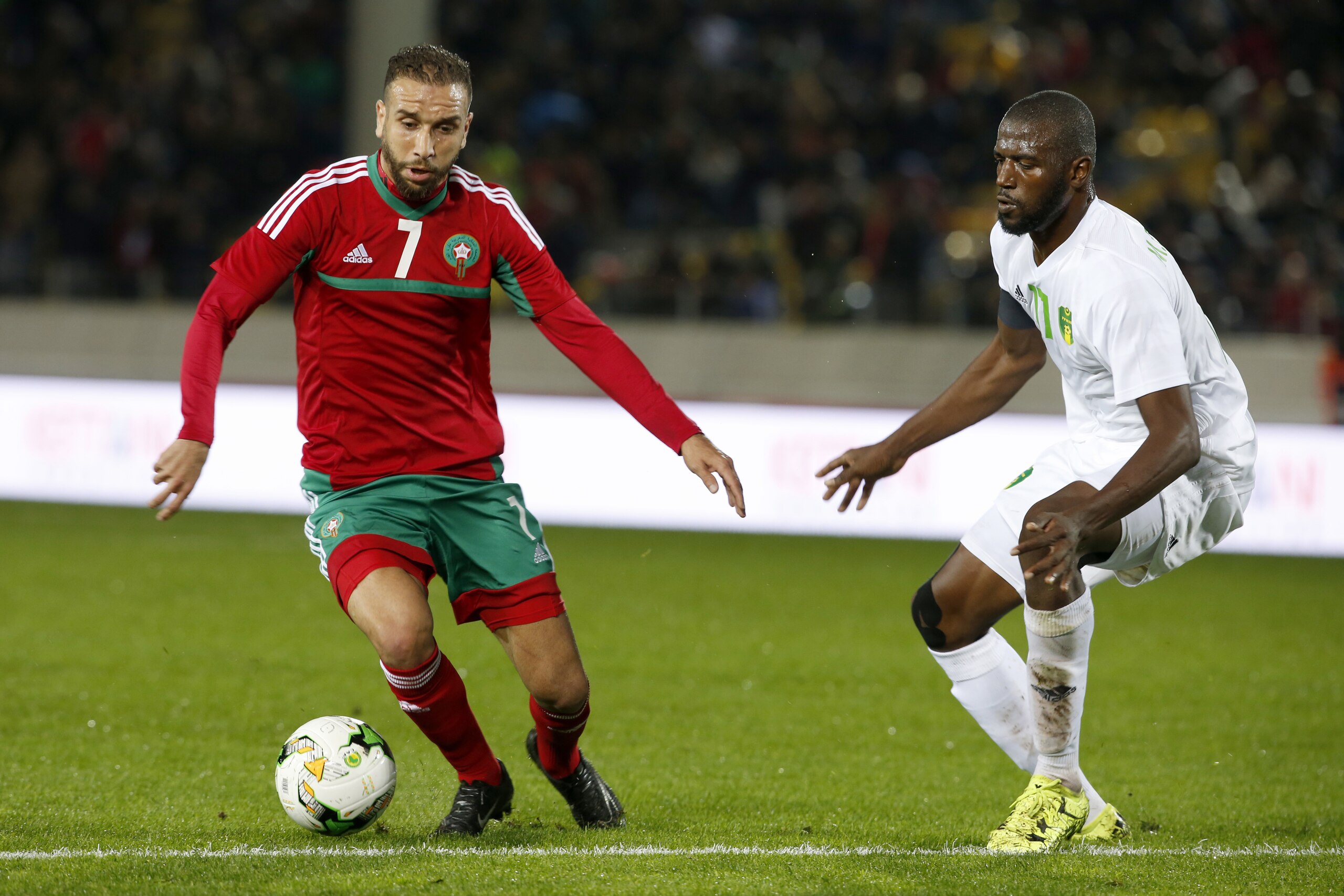 Morocco's Zakaria Hadraf, left, challenges the ball with Mauritania's Moussa Baghayoko during their CHAN (African Nations Championship) opening group A soccer match in Casablanca, Morocco, Saturday, Jan. 13, 2018.  (AP Photo/Abdeljalil Bounhar)