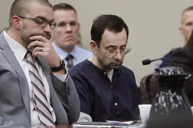 Larry Nassar sits with attorney Matt Newburg during his sentencing hearing Wednesday, Jan. 24, 2018, in Lansing, Mich. The former sports doctor who admitted molesting some of the nation's top gymnasts for years was sentenced Wednesday to 40 to 175 years in prison as the judge declared: