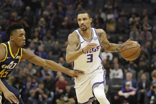 Sacramento Kings guard George Hill, right, drives against Utah Jazz guard Donovan Mitchell during the first quarter of an NBA basketball game Wednesday, Jan. 17, 2018, in Sacramento, Calif. (AP Photo/Rich Pedroncelli)