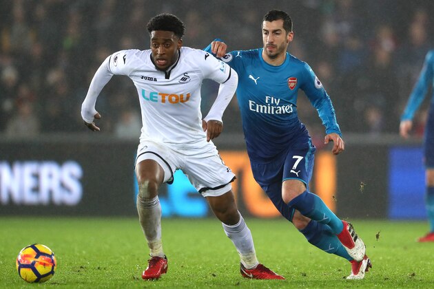 SWANSEA, WALES - JANUARY 30:  Leroy Fer of Swansea City competes with Henrikh Mkhitaryan of Arsenal during the Premier League match between Swansea City and Arsenal at Liberty Stadium on January 30, 2018 in Swansea, Wales.  (Photo by Matthew Ashton - AMA/Getty Images)