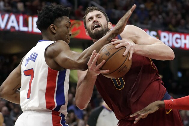 Detroit Pistons' Stanley Johnson, left, fouls Cleveland Cavaliers' Kevin Love in the first half of an NBA basketball game, Sunday, Jan. 28, 2018, in Cleveland. (AP Photo/Tony Dejak)