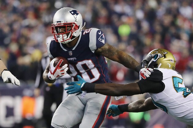 FOXBOROUGH, MA - JANUARY 21:  James White #28 of the New England Patriots carries the ball as he is defended by Eli Ankou #54 of the Jacksonville Jaguars in the fourth quarter during the AFC Championship Game at Gillette Stadium on January 21, 2018 in Foxborough, Massachusetts.  (Photo by Elsa/Getty Images)