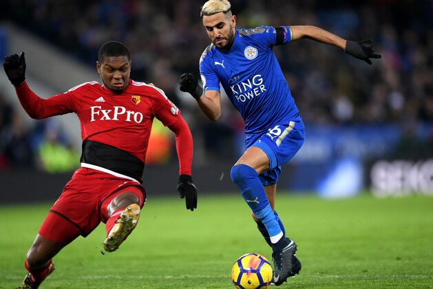 LEICESTER, ENGLAND - JANUARY 20:  Riyad Mahrez of Leicester City escapes a challenge from Marvin Zeegelaar of Watford on the way to the scoring his siddes first goal during the Premier League match between Leicester City and Watford at The King Power Stadium on January 20, 2018 in Leicester, England.  (Photo by Laurence Griffiths/Getty Images)
