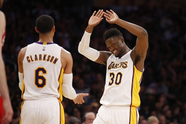Los Angeles Lakers forward Julius Randle, right, and Los Angeles Lakers guard Jordan Clarkson, left, celebrate with each other during the first half of an NBA basketball game, Sunday, March 12, 2017, in Los Angeles. (AP Photo/Danny Moloshok)