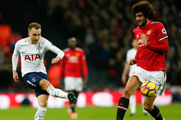 Tottenham Hotspur's Danish midfielder Christian Eriksen (L) plays the ball past Manchester United's Belgian midfielder Marouane Fellaini (R) during the English Premier League football match between Tottenham Hotspur and Manchester United at Wembley Stadium in London, on January 31, 2018. / AFP PHOTO / IKIMAGES / Ian KINGTON / RESTRICTED TO EDITORIAL USE. No use with unauthorized audio, video, data, fixture lists, club/league logos or 'live' services. Online in-match use limited to 45 images, no video emulation. No use in betting, games or single club/league/player publications.  /         (Photo credit should read IAN KINGTON/AFP/Getty Images)