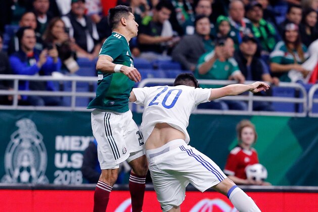 Mexico's Jesus Molina (L) heads the ball past Bosnia and Herzegovina's Goran Zakaric during a friendly  game at the Alamodome in San Antonio, Texas, on January 31, 2018. / AFP PHOTO / CHRIS COVATTA        (Photo credit should read CHRIS COVATTA/AFP/Getty Images)