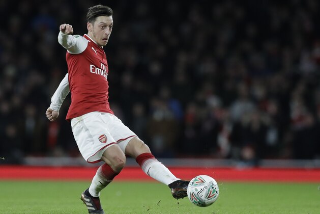 Arsenal's Mesut Ozil controls the ball during the English League Cup semifinal second leg soccer match between Chelsea and Arsenal at the Emirates stadium in London, Wednesday, Jan.24, 2018. (AP Photo/Matt Dunham)