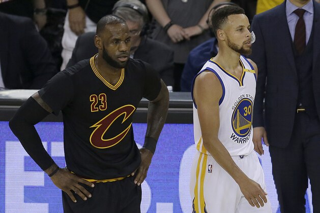 Cleveland Cavaliers forward LeBron James (23) and Golden State Warriors guard Stephen Curry (30) during the first half of Game 5 of basketball's NBA Finals in Oakland, Calif., Monday, June 12, 2017. (AP Photo/Ben Margot)