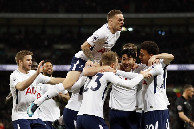 Tottenham's Christian Eriksen, center with back to camera, celebrates after scoring the opening goal during the English Premier League soccer match between Tottenham Hotspur and Manchester United at Wembley stadium in London, England, Wednesday, Jan. 31, 2018. (AP Photo/Kirsty Wigglesworth)