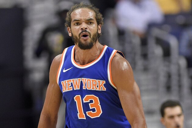 New York Knicks center Joakim Noah (13) reacts during the second half of a preseason NBA basketball game against the Washington Wizards, Friday, Oct. 6, 2017, in Washington. The Wizards won 104-100. (AP Photo/Nick Wass)