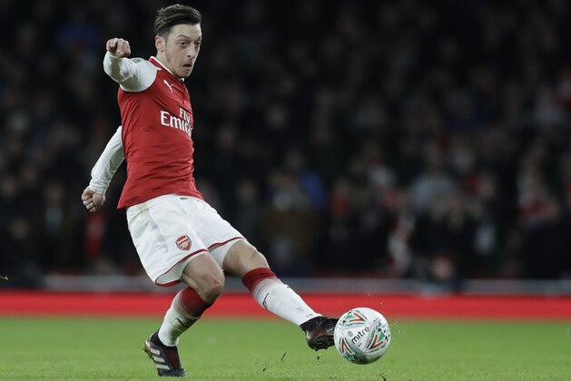 Arsenal's Mesut Ozil controls the ball during the English League Cup semifinal second leg soccer match between Chelsea and Arsenal at the Emirates stadium in London, Wednesday, Jan.24, 2018. (AP Photo/Matt Dunham)