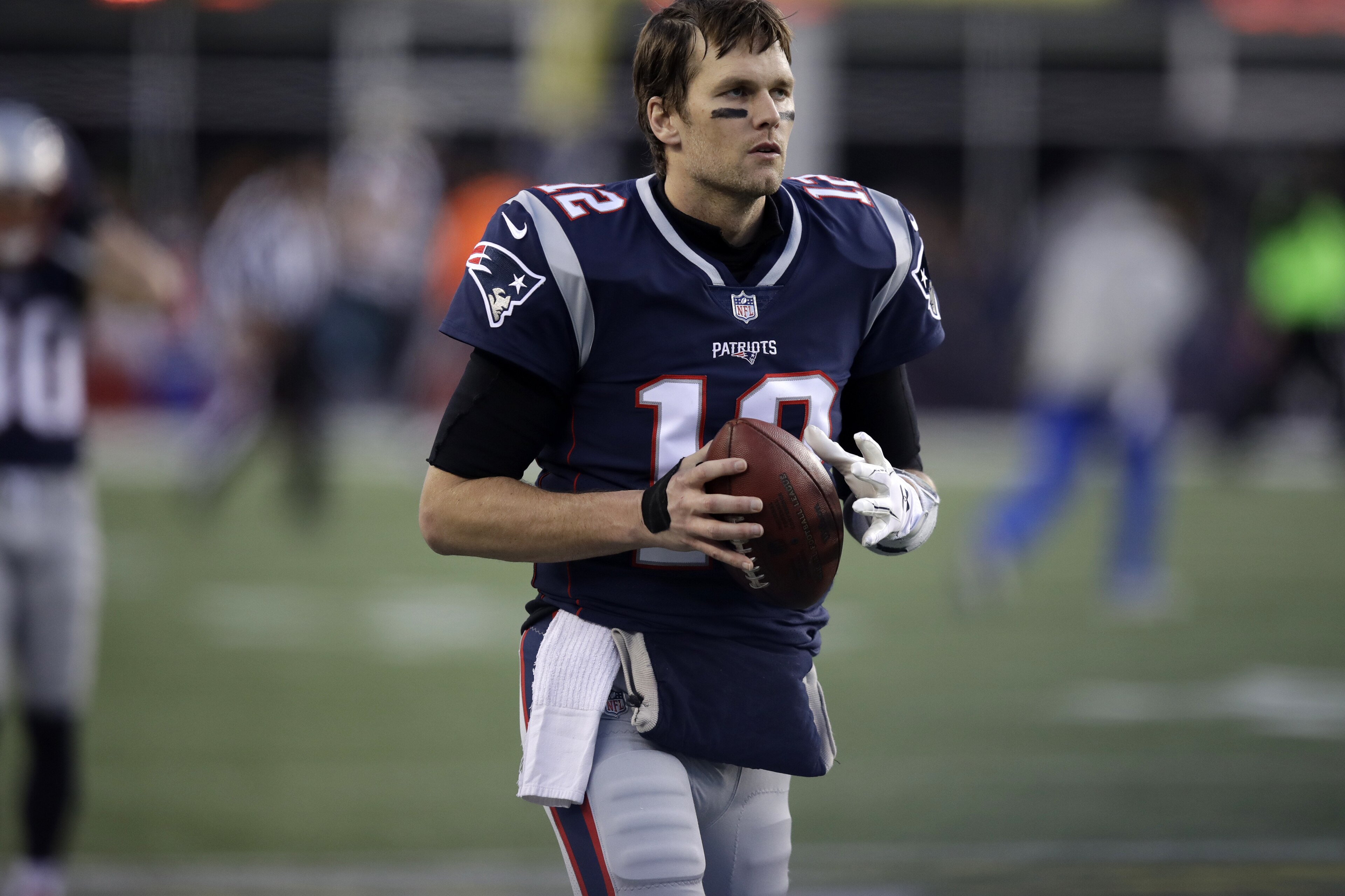 New England Patriots quarterback Tom Brady (12) warms up before the second half of the AFC championship NFL football game against the Jacksonville Jaguars, Sunday, Jan. 21, 2018, in Foxborough, Mass. (AP Photo/Charles Krupa)