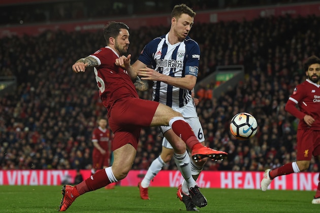 Liverpool's English striker Danny Ings (L) shoots under pressure from West Bromwich Albion's Northern Irish defender Jonny Evans during the English FA Cup fourth round football match between Liverpool and West Bromwich Albion at Anfield in Liverpool, north west England on January 27, 2018. / AFP PHOTO / PAUL ELLIS / RESTRICTED TO EDITORIAL USE. No use with unauthorized audio, video, data, fixture lists, club/league logos or 'live' services. Online in-match use limited to 75 images, no video emulation. No use in betting, games or single club/league/player publications.  /         (Photo credit should read PAUL ELLIS/AFP/Getty Images)