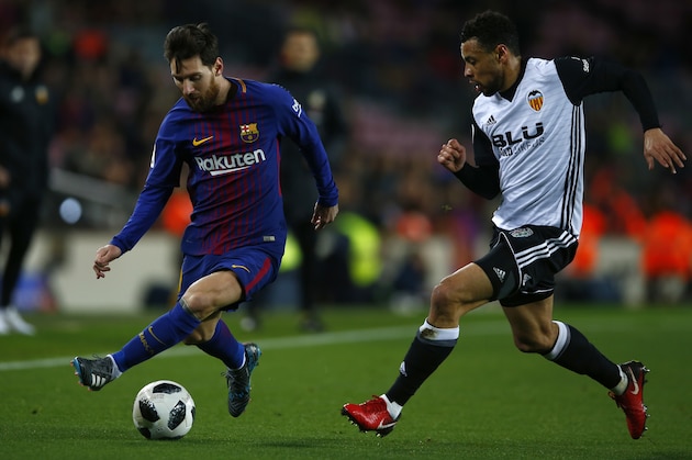 FC Barcelona's Lionel Messi, left, with Valencia's Francis Coquelin during the Spanish Copa del Rey, semifinal, first leg, soccer match between FC Barcelona and Valencia at the Camp Nou stadium in Barcelona, Spain, Thursday, Feb. 1, 2018. (AP Photo/Manu Fernandez)