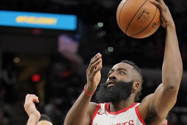 Houston Rockets' James Harden (13) shoots next to San Antonio Spurs' Danny Green during the first half of an NBA basketball game Thursday, Feb. 1, 2018, in San Antonio. (AP Photo/Darren Abate)