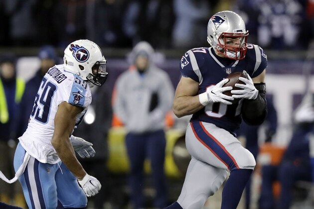 New England Patriots tight end Rob Gronkowski (87) catches a pass in front of Tennessee Titans linebacker Wesley Woodyard (59) during the second half of an NFL divisional playoff football game, Saturday, Jan. 13, 2018, in Foxborough, Mass. (AP Photo/Charles Krupa)