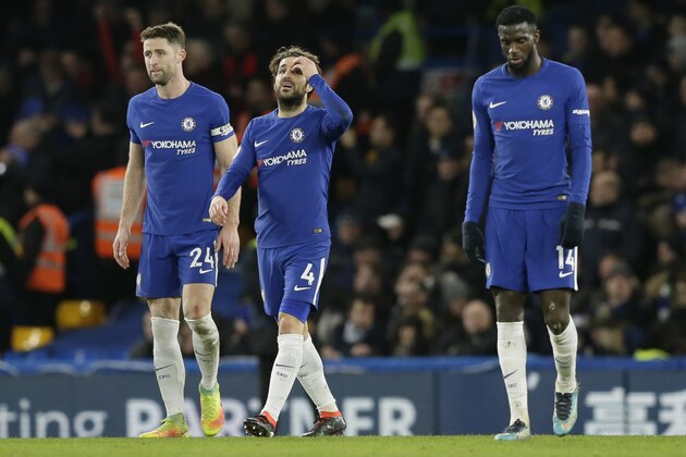 Chelsea's Cesc Fabregas, centre, Gary Cahill, left, and Tiemoue Bakayoko look dejected after Bournemouth's third goal during the English Premier League soccer match between Chelsea and Bournemouth at Stamford Bridge in London, Wednesday Jan. 31, 2018. (AP Photo/Tim Ireland)