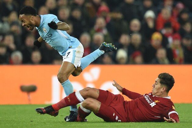 Manchester City's English midfielder Raheem Sterling (L) goes down as Liverpool's Brazilian midfielder Roberto Firmino (R) attempts a tackle during the English Premier League football match between Liverpool and Manchester City at Anfield in Liverpool, north west England on January 14, 2018. / AFP PHOTO / Oli SCARFF / RESTRICTED TO EDITORIAL USE. No use with unauthorized audio, video, data, fixture lists, club/league logos or 'live' services. Online in-match use limited to 75 images, no video emulation. No use in betting, games or single club/league/player publications.  /         (Photo credit should read OLI SCARFF/AFP/Getty Images)