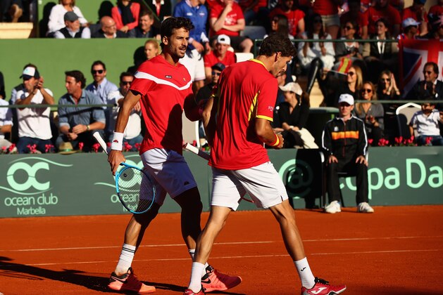 MARBELLA, SPAIN - FEBRUARY 03:  Pablo Carreno Busta and Feliciano Lopez of Spain celebrate a point against Dom Inglot and Jamie Murray of Great Britain in the doubles during day two of the Davis Cup World Group first round match between Spain and Great Britain at Club de Tenis Puente Romano on February 2, 2018 in Marbella, Spain.  (Photo by Julian Finney/Getty Images)