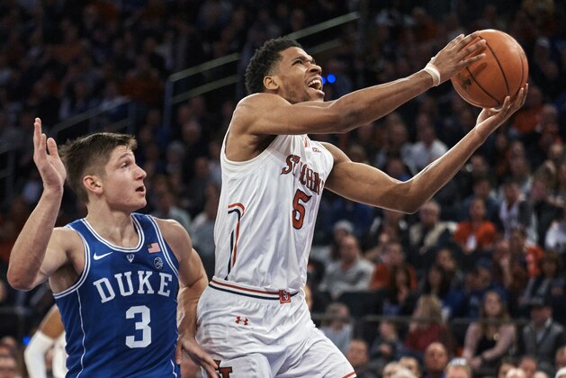 St. John's Justin Simon (5) drives to the basket past Duke's Grayson Allen (3) during the first half of an NCAA college basketball game at Madison Square Garden in New York, Saturday, Feb. 3, 2018. (AP Photo/Andres Kudacki)