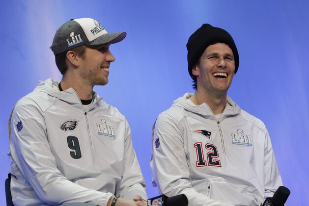 Philadelphia Eagles' Nick Foles and New England Patriots' Tom Brady answer questions during NFL football Super Bowl 52 Opening Night Monday, Jan. 29, 2018, at the Xcel Center in St. Paul, Minn. (AP Photo/Eric Gay)