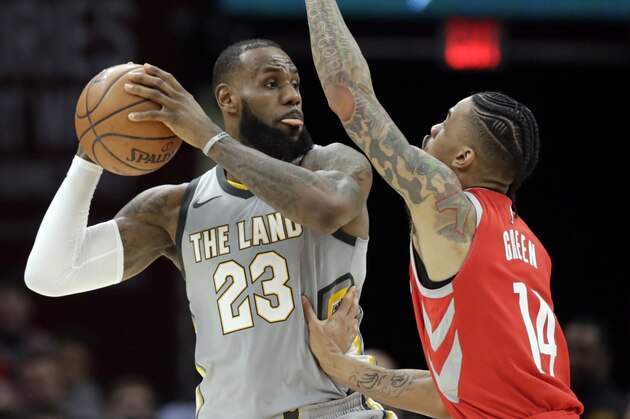Cleveland Cavaliers' LeBron James (23) looks to pass over Houston Rockets' Gerald Green (14) in the second half of an NBA basketball game, Saturday, Feb. 3, 2018, in Cleveland. (AP Photo/Tony Dejak)