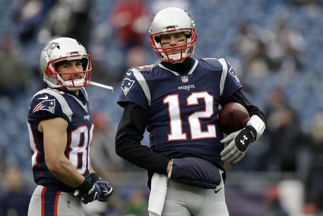 New England Patriots quarterback Tom Brady (12) talks to wide receiver Danny Amendola (80) as they warm up before an NFL football game against the Buffalo Bills, Sunday, Dec. 24, 2017, in Foxborough, Mass. (AP Photo/Charles Krupa)