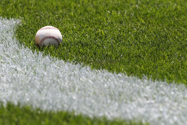 A baseball sits on the field near a part of a New York Yankees logo before a baseball game between the Oakland Athletics and New York Yankees in New York on Sunday, May 5, 2013. (AP Photo/Peter Morgan)