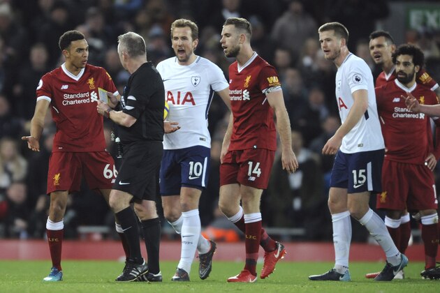 Referee Jonathan Moss talks to Liverpool's Trent Alexander-Arnold, left, during the English Premier League soccer match between Liverpool and Tottenham Hotspur at Anfield, Liverpool, England, Sunday, Feb. 4, 2018. (AP Photo/Rui Vieira)