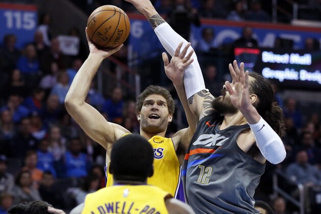Los Angeles Lakers center Brook Lopez, top left, shoots in front of Oklahoma City Thunder center Steven Adams (12) in the first half of an NBA basketball game in Oklahoma City, Sunday, Feb. 4, 2018. (AP Photo/Sue Ogrocki)