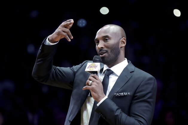 Former Los Angeles Laker Kobe Bryant speaks during a halftime ceremony retiring both of his jersey's during an NBA basketball game between the Los Angeles Lakers and the Golden State Warriors, in Los Angeles, Monday, Dec. 18, 2017. (AP Photo/Chris Carlson)