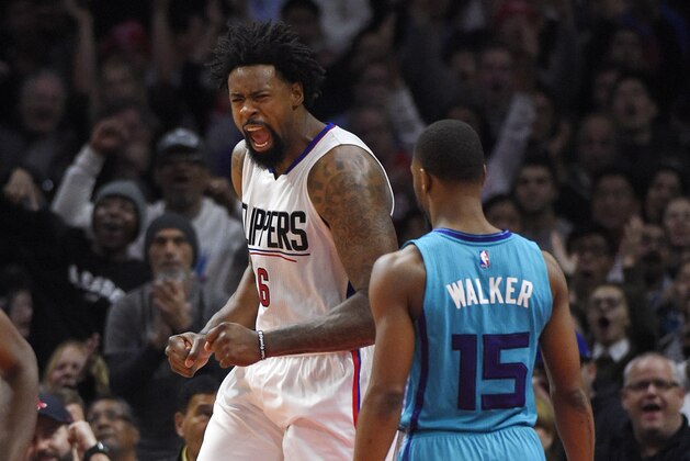 Los Angeles Clippers center DeAndre Jordan, left, reacts after scoring as Charlotte Hornets guard Kemba Walker watches during the second half of an NBA basketball game, Saturday, Jan. 9, 2016, in Los Angeles. The Clippers won 97-83. (AP Photo/Mark J. Terrill)