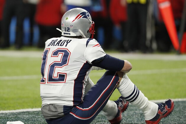 New England Patriots' Tom Brady sits on the field after the NFL Super Bowl 52 football game against the Philadelphia Eagles Sunday, Feb. 4, 2018, in Minneapolis. The Eagles won 41-33. (AP Photo/Charlie Neibergall)