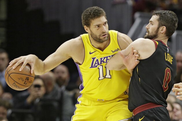 Los Angeles Lakers' Brook Lopez (11) drives past Cleveland Cavaliers' Kevin Love (0) in the first half of an NBA basketball game, Thursday, Dec. 14, 2017, in Cleveland. (AP Photo/Tony Dejak)
