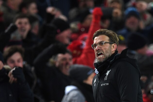 Liverpool's German manager Jurgen Klopp celebrates Liverpool's Egyptian midfielder Mohamed Salah scoring the team's second goal during the English Premier League football match between Liverpool and Tottenham Hotspur at Anfield in Liverpool, north west England on February 4, 2018. / AFP PHOTO / Paul ELLIS / RESTRICTED TO EDITORIAL USE. No use with unauthorized audio, video, data, fixture lists, club/league logos or 'live' services. Online in-match use limited to 75 images, no video emulation. No use in betting, games or single club/league/player publications.  /         (Photo credit should read PAUL ELLIS/AFP/Getty Images)