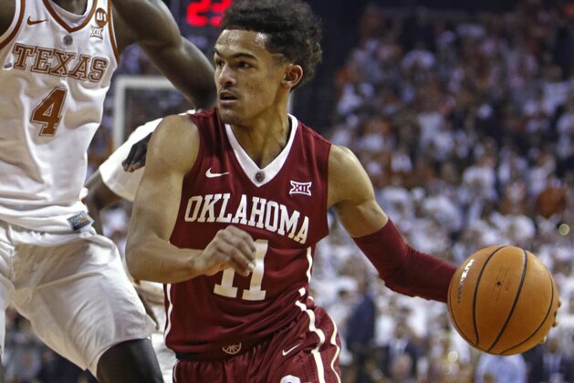 Oklahoma guard Trae Young (11) drives the ball against Texas center Mohamed Bamba (4) during the first half of an NCAA college basketball game, Saturday, Feb. 3, 2018, in Austin, Texas. (AP Photo/Michael Thomas)