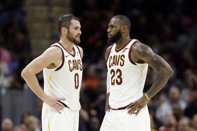 Cleveland Cavaliers' Kevin Love (0) talks with LeBron James (23) in the first half of an NBA basketball game against the Orlando Magic, Saturday, Oct. 21, 2017, in Cleveland. (AP Photo/Tony Dejak)