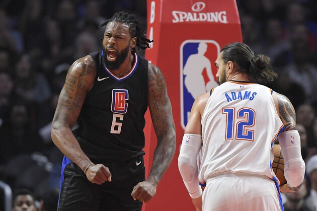 Los Angeles Clippers center DeAndre Jordan, left, gestures after scoring as Oklahoma City Thunder center Steven Adams, of New Zealand, takes the ball during the first half of an NBA basketball game, Thursday, Jan. 4, 2018, in Los Angeles. (AP Photo/Mark J. Terrill)