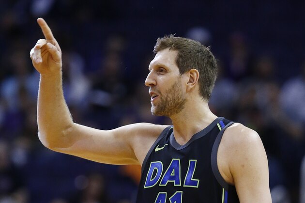 Dallas Mavericks forward Dirk Nowitzki waves to the Phoenix Suns bench prior to an NBA basketball game against the Suns, Wednesday, Jan. 31, 2018, in Phoenix. The Suns defeated the Mavericks 102-88. (AP Photo/Ross D. Franklin)