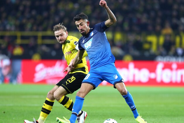 Dortmund, Germany - DECEMBER 16: Marcel Schmelzer of Dortmund and Kerem Demirbay of Hoffenheim battle for the ball during the Bundesliga match between Borussia Dortmund and TSG 1899 Hoffenheim at Signal Iduna Park on December 16, 2017 in Dortmund, Germany. (Photo by TF-Images/TF-Images via Getty Images)