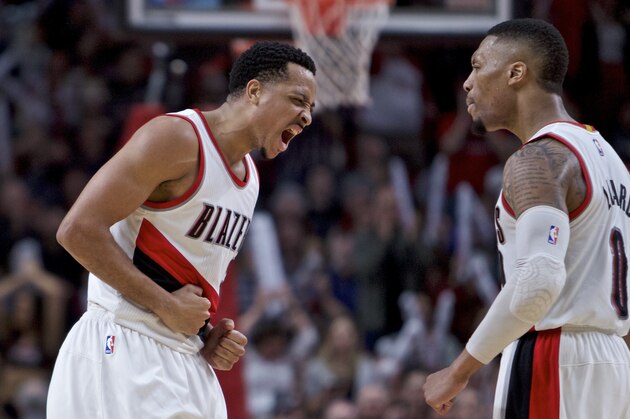 Portland Trail Blazers guard CJ McCollum, left, and guard Damian Lillard react after McCollum scored late in the second half of an NBA basketball game against the Milwaukee Bucks in Portland, Ore., Tuesday, March 21, 2017. The Bucks won 93-90. (AP Photo/Craig Mitchelldyer)