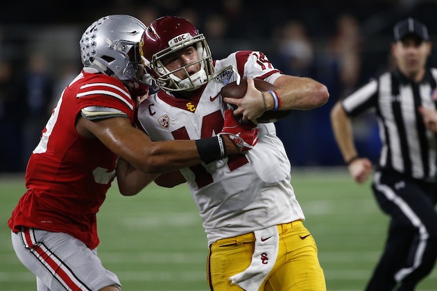 ARLINGTON, TX - DECEMBER 29: Malik Harrison #39 of the Ohio State Buckeyes runs Sam Darnold #14 of the USC Trojans out of bounds in the second half of the 82nd Goodyear Cotton Bowl Classic between USC and Ohio State at AT&T Stadium on December 29, 2017 in Arlington, Texas. Ohio State won 24-7.  (Photo by Ron Jenkins/Getty Images)