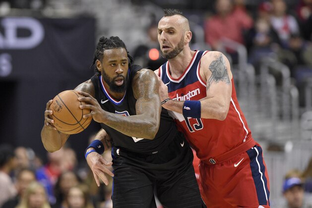 Los Angeles Clippers center DeAndre Jordan (6) handles the ball against Washington Wizards center Marcin Gortat (13), of Poland, during the second half of an NBA basketball game, Friday, Dec. 15, 2017, in Washington. The Wizards won 100-91. (AP Photo/Nick Wass)