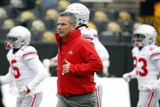 FILE - In this Nov, 4, 2017, file photo, Ohio State head coach Urban Meyer runs onto the field before an NCAA college football game against Iowa in Iowa City, Iowa. Meyer wants to be sure his team doesn't overlook Illinois, which visits Ohio Stadium on Saturday. (AP Photo/Charlie Neibergall, File)