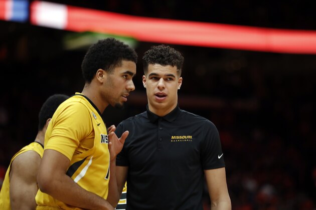Missouri's Michael Porter Jr., right, talks with his brother Jontay Porter during the first half of an NCAA college basketball game against Illinois Saturday, Dec. 23, 2017, in St. Louis. (AP Photo/Jeff Roberson)