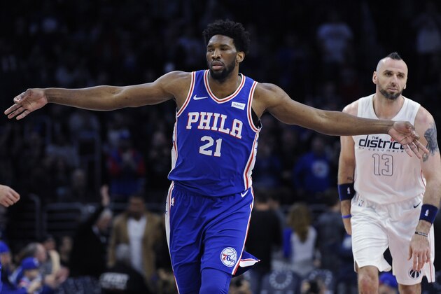 Philadelphia 76ers' Joel Embiid (21) celebrates after scoring three points while Washington Wizards' Marcin Gortat looks on in the first half of an NBA basketball game, Tuesday, Feb 6, 2018, in Philadelphia. (AP Photo/Michael Perez)
